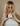 Woman with long blonde hair holding the Mimane Glow Hydrate and Strengthen Hair Mask