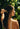 Woman combing back wet hair with a wooden comb outdoors