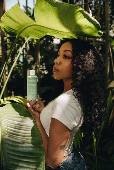 Model holding Mimane Glow Nourish and Strengthen Conditioner — natural luxury conditioner