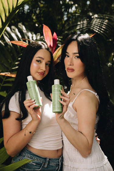 Model holding Mimane Glow Nourish and Strengthen Shampoo and Conditioner — part of the Glow Kit routine