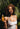Woman holding Growth & Strengthen Hair Oil bottle