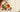 Argan nuts and a glass of golden oil on linen