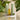 Mimane Glow hair oil, shampoo, and conditioner on marble podiums with botanicals