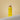 Mimane Glow Growth and Strengthen Hair Oil bottle on a warm beige backdrop