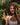 Model holding Mimane Glow Growth and Strengthen Hair Oil — natural hair growth oil